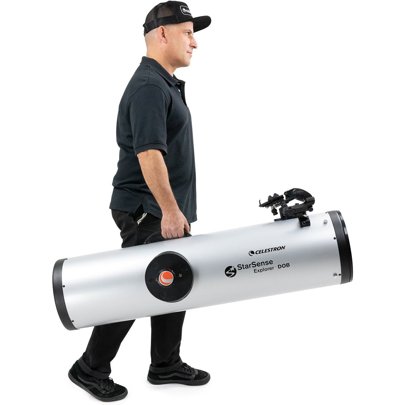 Observer carrying the Celestron StarSense Explorer 10-inch Dobsonian optical tube separately from its base